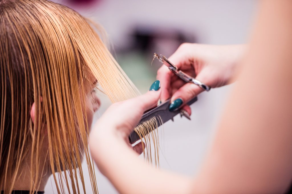 graphicstock hands of unrecognizable professional hairdresser cutting hair of her client giving a new haircut to female customer BujUvrHG