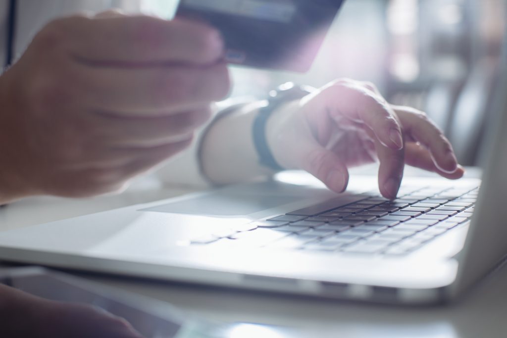 graphicstock young man holding credit card and using laptop computer online shopping conceptclose up and selected focus B PAAoweoe